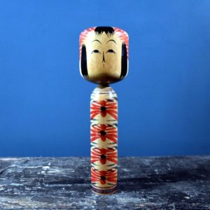 Togatta Kokeshi doll with chrysanthemum design