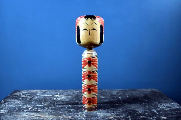 Togatta Kokeshi doll with chrysanthemum design