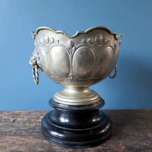 Antique silver plated champagne bucket on ebonised plinth