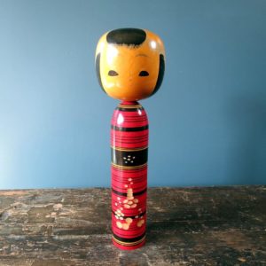 Japanese Kokeshi doll - Tsuchiyu style with bold coloured body and 3D petal design