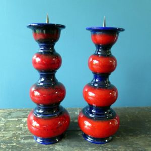 Pair of red and black Everard and Gallo candle holders